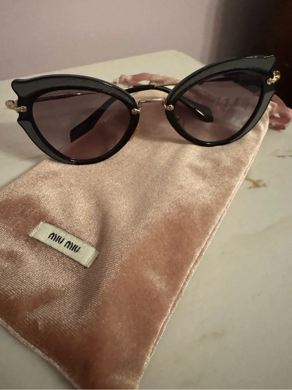 Miu Miu Black Cat-Eye Sunglasses with Gold Accents